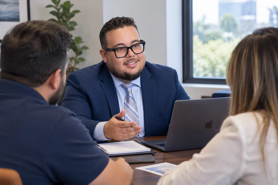Michael Linares speaking with two people during an editorial session